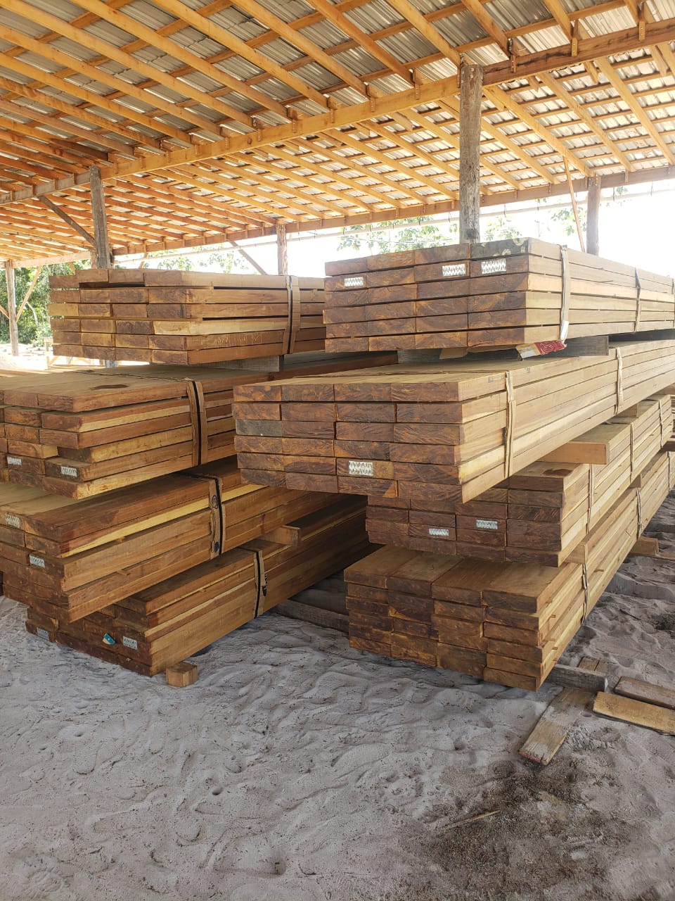 Bundles of rough sawn lumber stored under the mill roof